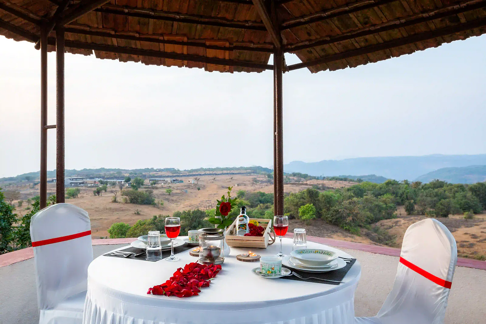 A table set in a gazebo overlooking the valley