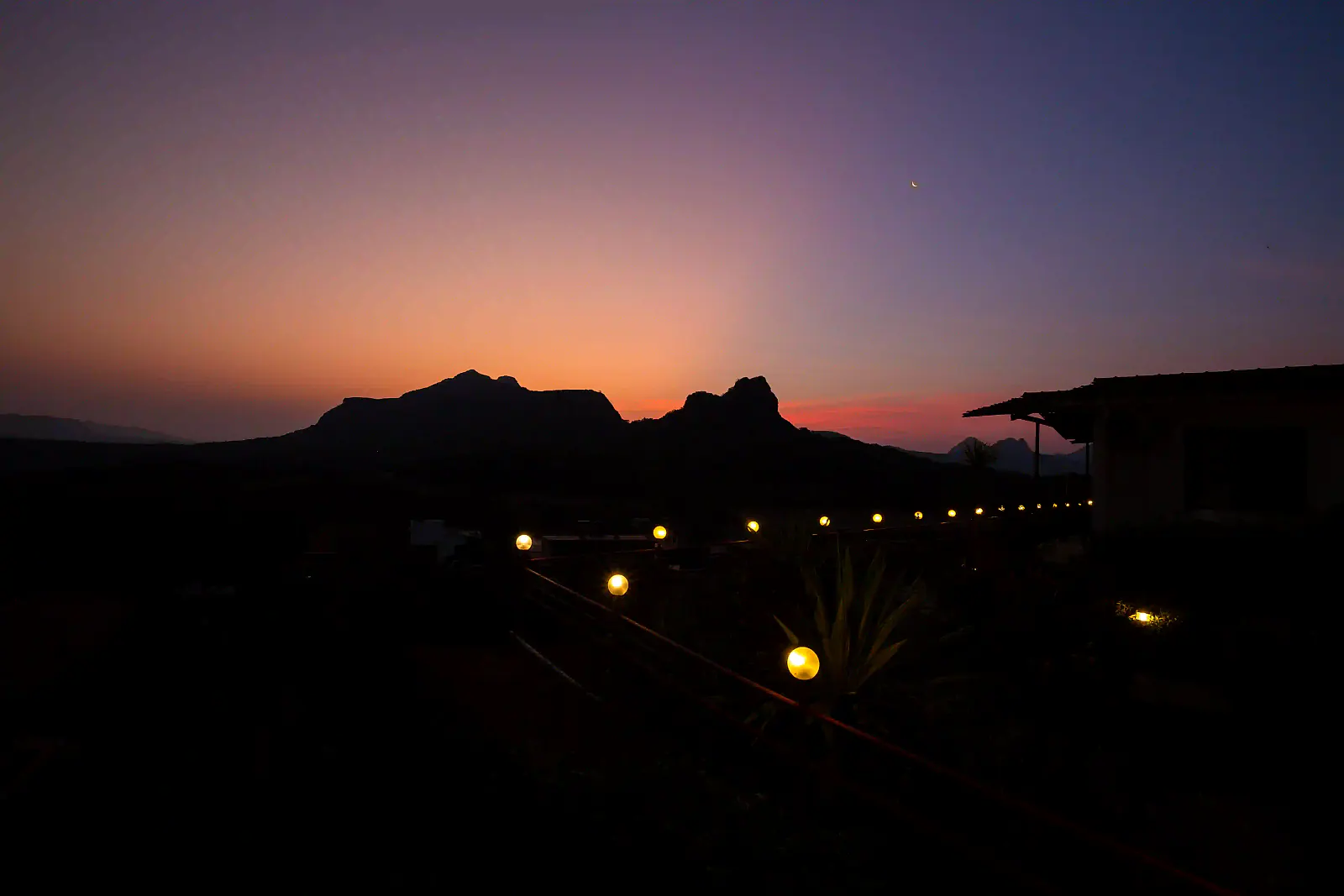 The hills at dusk with the first lights of the valley