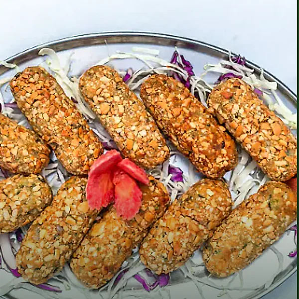 A platter of crisp, nut-crusted starters on shredded cabbage