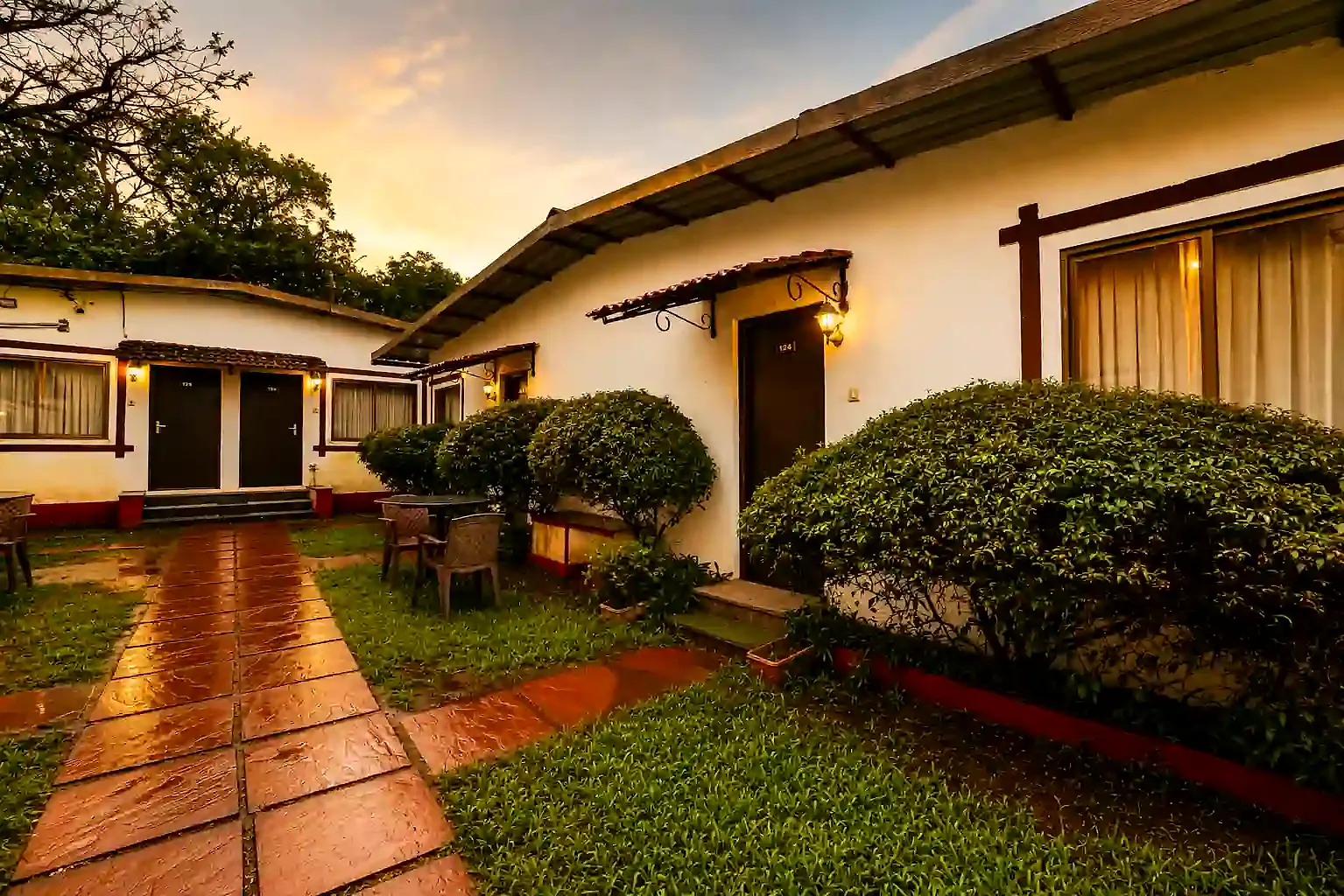 Cloud 9 cottages around a garden lawn at dusk