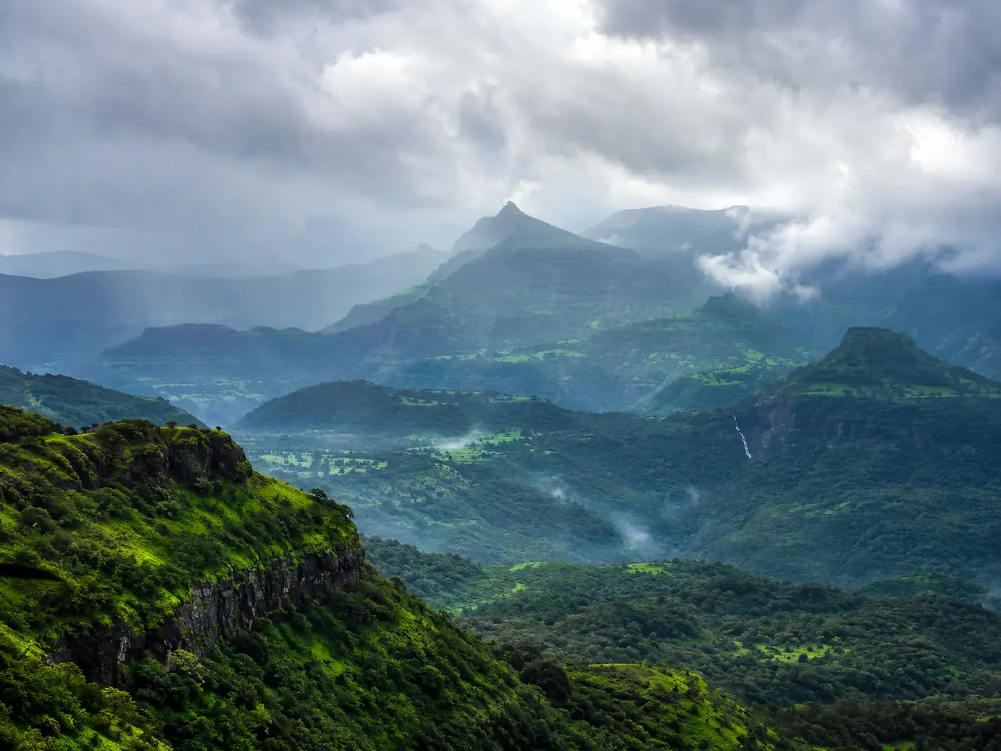 Monsoon clouds over the green Sahyadri ridges around Amby Valley